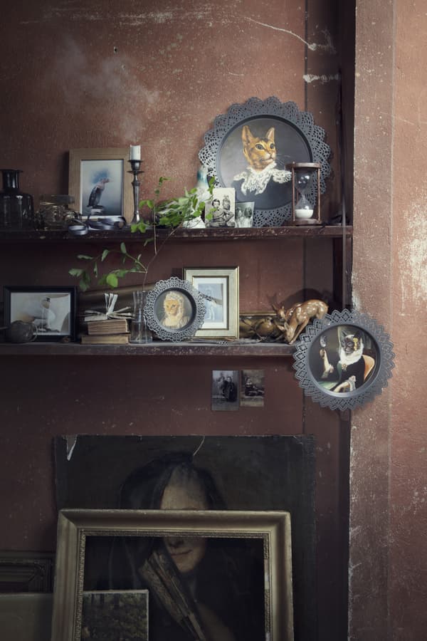 Two shelves filled with a variety of ornaments and pictures, including SKURAR decorations.