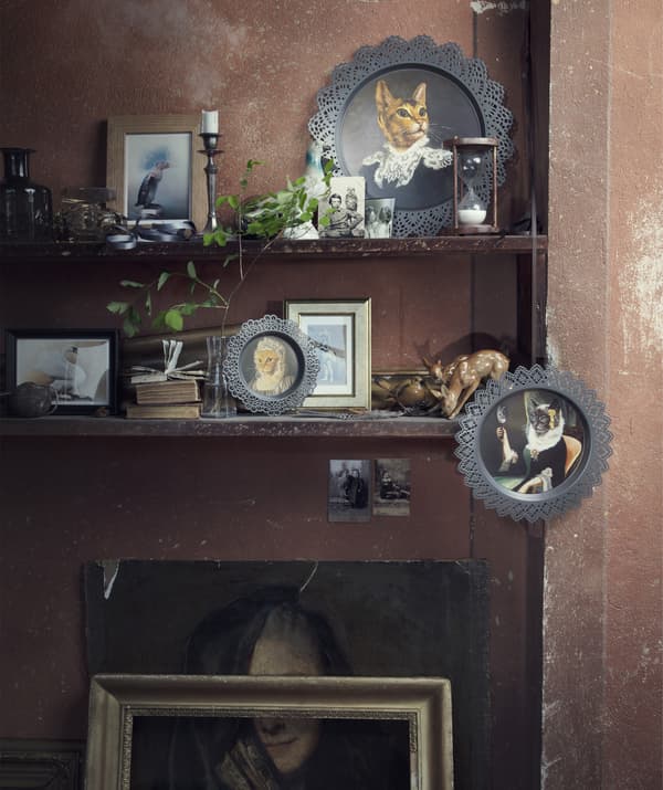 Two shelves filled with a variety of ornaments and pictures, including SKURAR decorations.