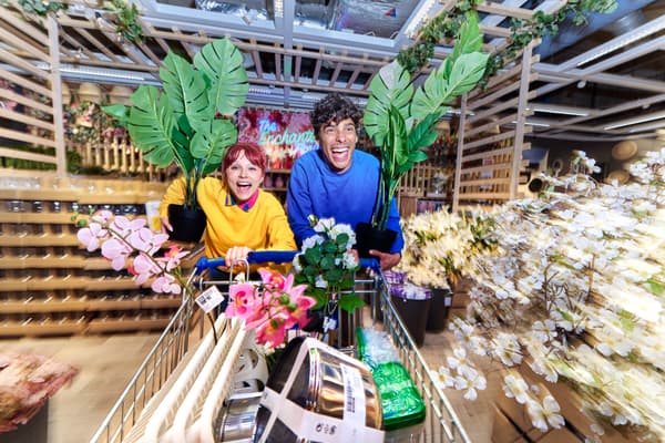 Two shoppers dashing with a shopping trolley