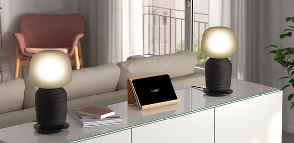 Two SYMFONISK table lamp with WiFi speaker units placed on a cabinet to create a stereo pair.