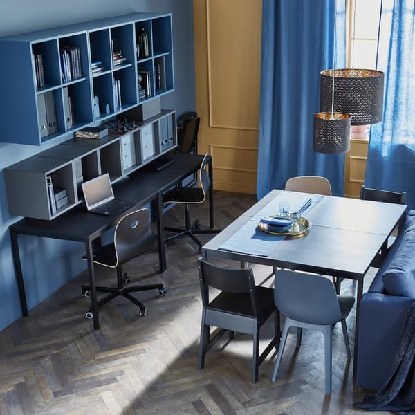 Two tables are placed together to create an everyday dining table, while two others sit against a wall as a workspace.