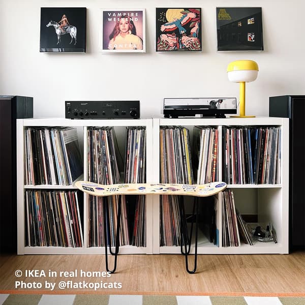 Two white KALLAX shelving unit being placed next to each other to house homeowner @flatkopicats vinyl player and collections. IKEA in real homes Photo by @flatkopicats