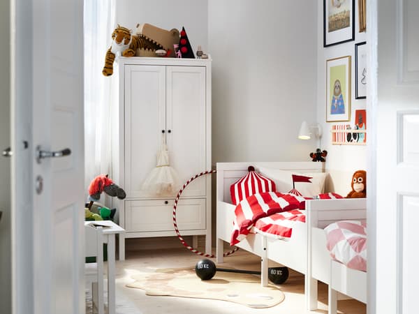 Two white SUNDVIK extendable beds stand end to end against a wall near a white SUNDVIK wardrobe in a bedroom.