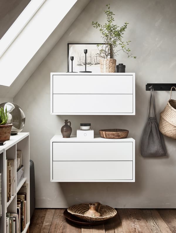 Two white wall units with small decorative items on top.