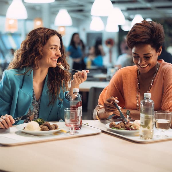 Two women are enjoying a dish from the Swedish restaurant. 
