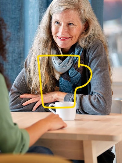 Two women are sitting opposite each other and drinking coffee in the Swedish restaurant in store