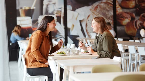 Two women eating a meal in the Swedish Restaurant.