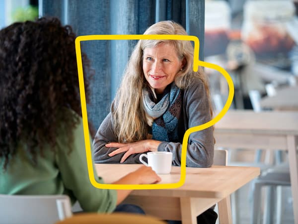 Two women having a coffee at a restaurant.