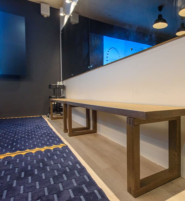 Two wooden benches placed beside each other.