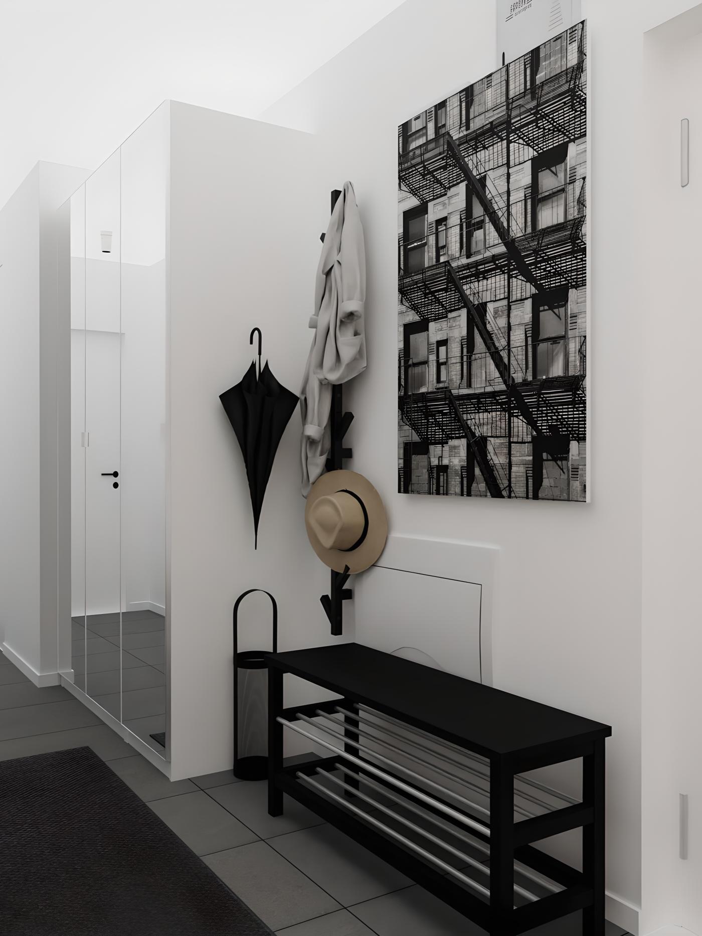 Ulazni hodnik s crno-bijelom slikom zgrade, crnom klupom, vješalicom s kišobranom, šeširom i kaputom te ogledalom na ormaru.