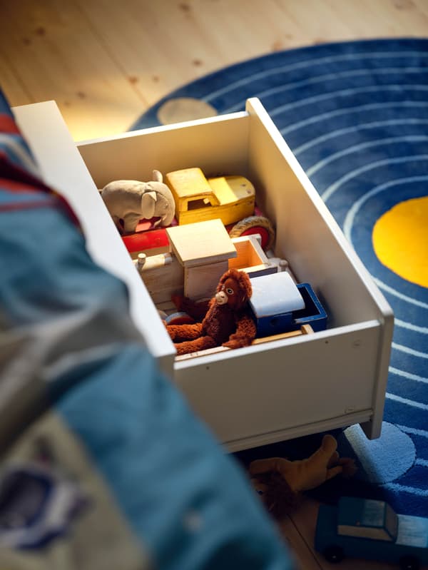 Úložný diel s kolieskami SLÄKT s hračkami.