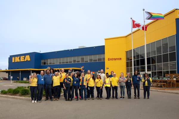Un groupe de collègues est rassemblé devant un magasin IKEA.