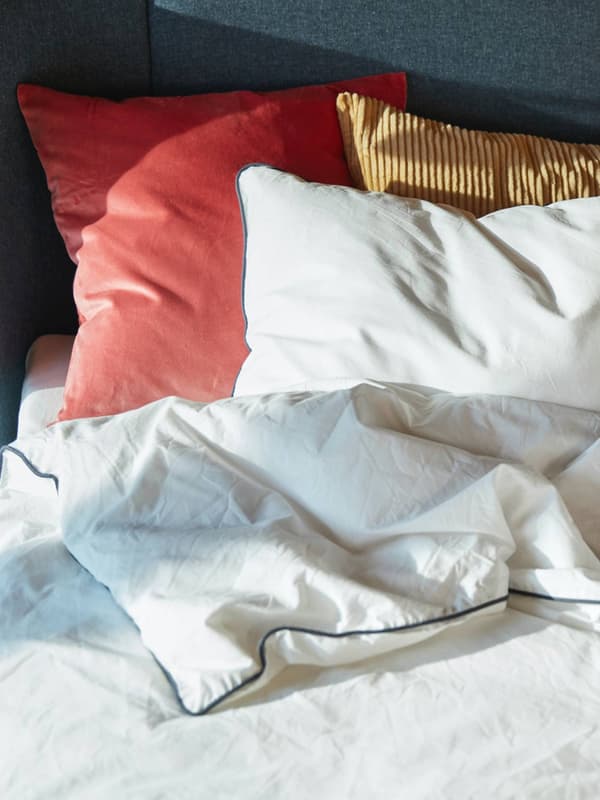 Un letto con copripiumino e due federe di diversi colori KUNGSBLOMMA
