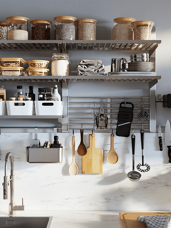 Un mur de cuisine auquel sont accrochés des rangements muraux de cuisine IKEA et des ustensiles.