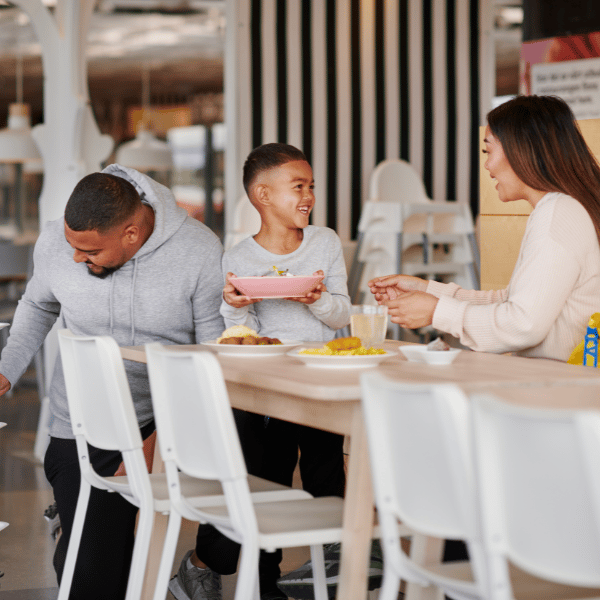 Un père, une mère et un enfant sont à table à IKEA au restaurant 