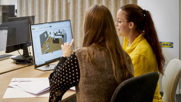 Una co-worker IKEA che aiuta una cliente a progettare una cucina. 