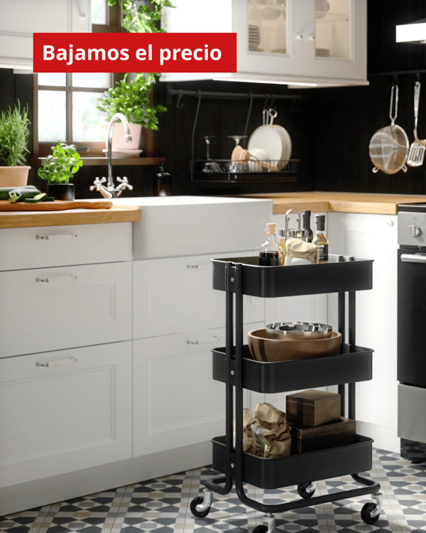 Una cocina con un carrito de cocina con implementos en sus bandejas.