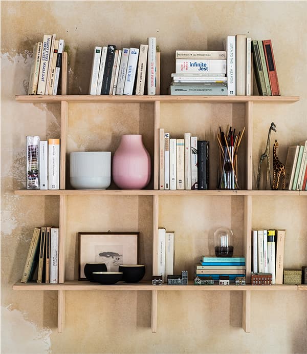 Una combinazione a parete con vasi, libri e altre decorazioni.