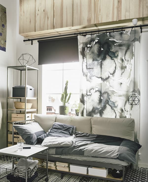 Una hilera de armarios IVAR colocados cerca del techo en este loft sirve para almacenar y amplía el espacio.