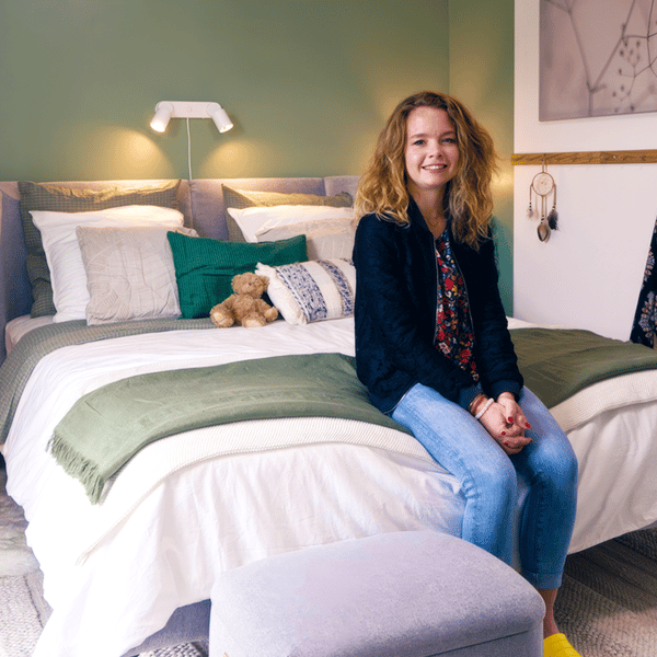 Une femme assise sur le bord de son lit