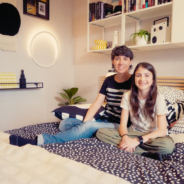 Une femme et sa fille sont assises sur leur lit