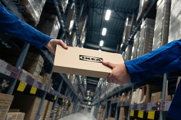 Upakovani IKEA paket koji ide iz jedne ruke u drugu.