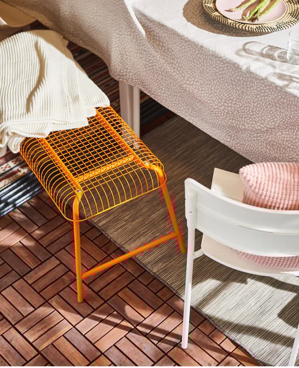 Update a steel bench with some cosy cushions to make a comfier seating spot for your guests. IKEA VÄSTERÖN orange bench made from powder-coated steel is durable and easy to care for.