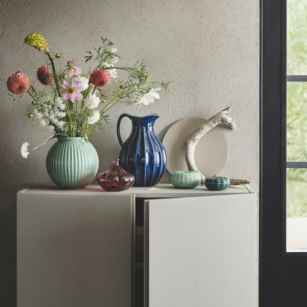 VANLIGEN series with a round green vase, a blue vase/jug, a small red glass vase and green decoration boxes.