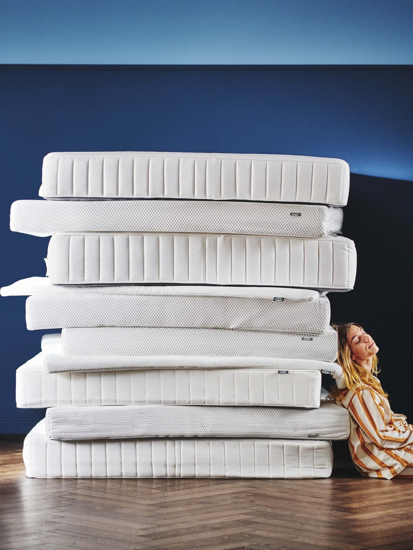 Various mattresses and pillows are stacked on top of each other.