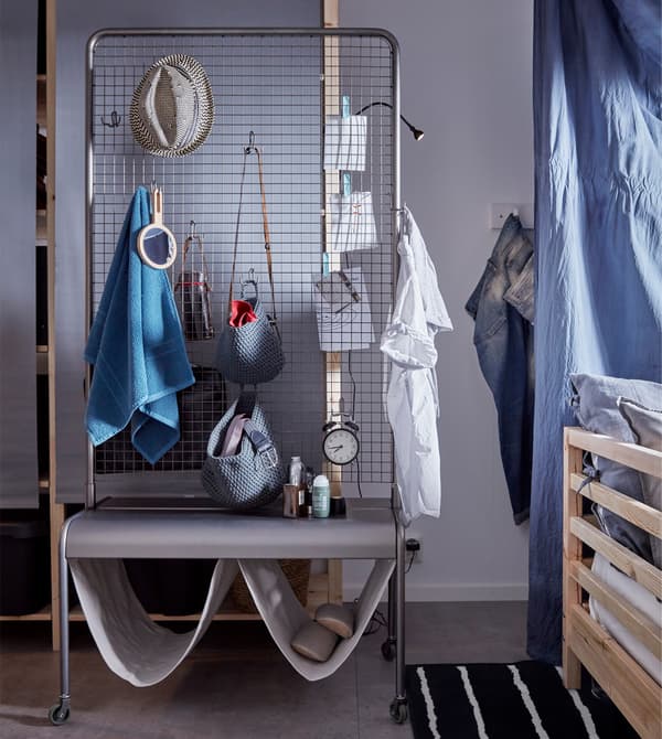VEBERÖD room divider from IKEA is practical and clever dorm room idea because it has lots of storage space and spots for decoration, too. Plus, it’s made of sturdy steel and has castors so you can easily roll it anywhere.  