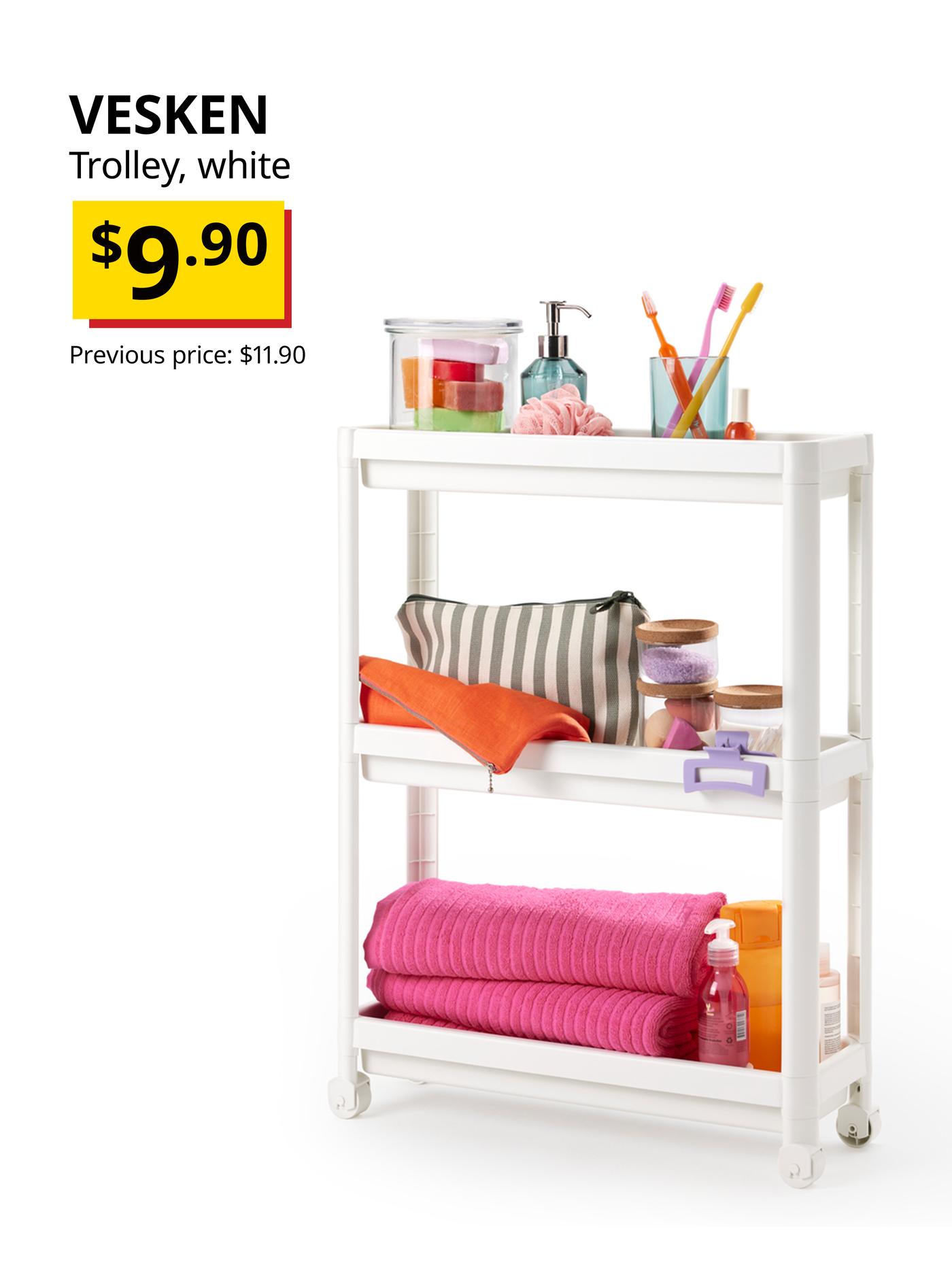 VESKEN bathroom trolley with an assortment of bath towels, storage containers, toothbrushesm soap dispensers and other items placed on the different shelves. 
