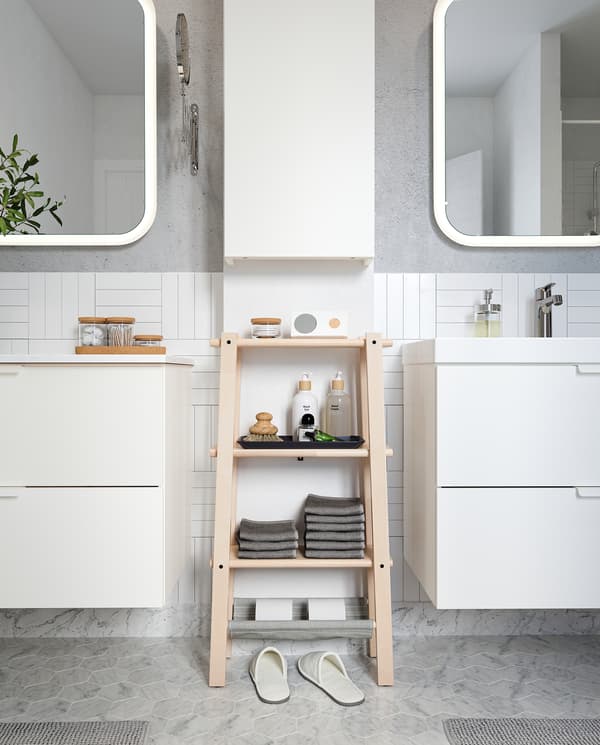 VILTO shelving unit in birch stands between two wash-stands and offers easy-reach storage for folded towels and perfumes.
