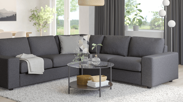 VIMLE modular sofa in grey in a cozy living room setting, decorated with soft lighting, round coffee table, and a white rug.