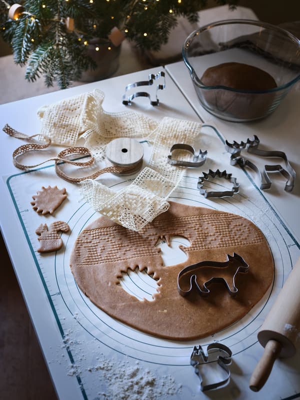 VINTERSAGA gingerbread dough is rolled out on a table, with VINTER 2020 pastry cutters used to cut animal shapes in it.