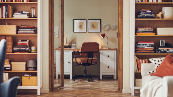 Vsita a un escritorio desde un living con estants y decoraciones.