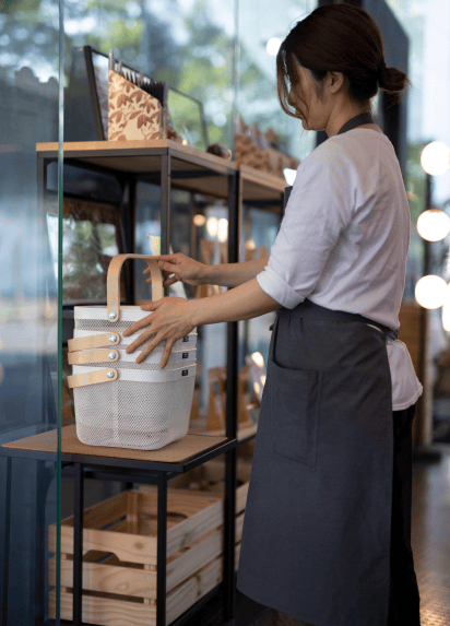 Waitress tyiding up a shelf