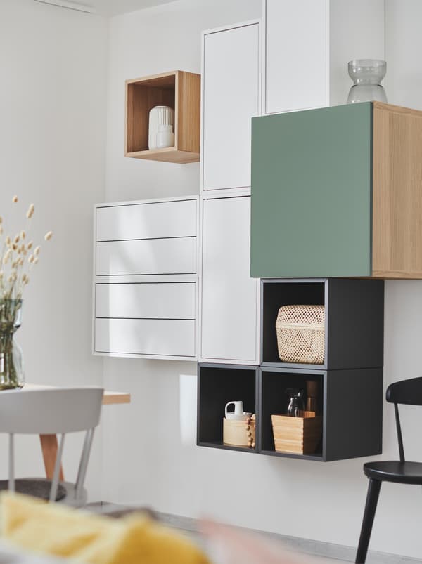 Wall section with EKET shelving units combined with other storage units, creating a deliberately irregular yet geometric look.