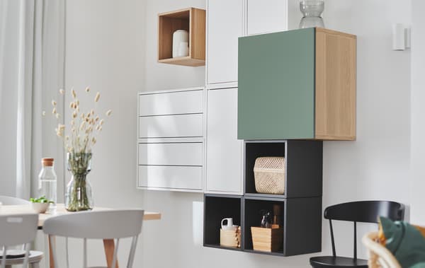 Wall section with EKET shelving units combined with other storage units, creating a deliberately irregular yet geometric look.