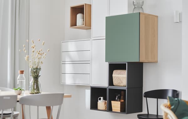 Wall section with EKET shelving units combined with other storage units, creating a deliberately irregular yet geometric look.