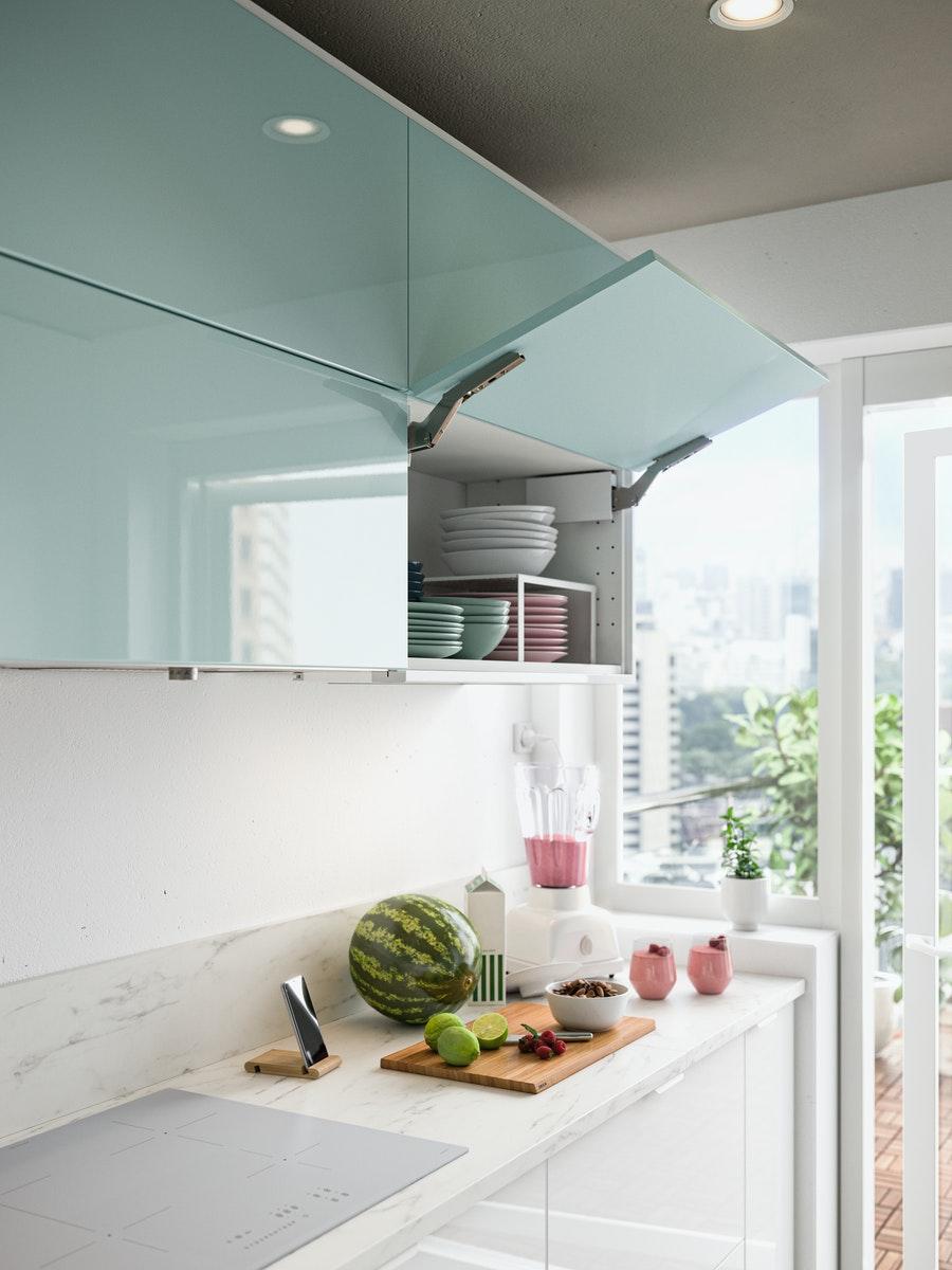 Wandschränke mit horizontalen KALLARP Türen in hochglanz helltürkis. Ein Schrank ist aufgeklappt.