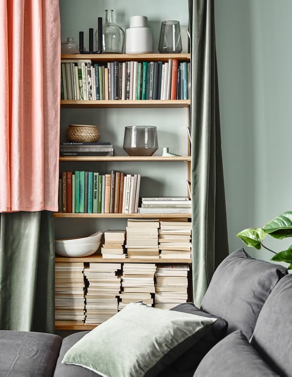 Want some balance in your living room? Hide a full shelf with some curtains. IKEA offers a wide selection of home textiles and curtains, such as LEJONGAP pink curtains. The natural material gives the curtains a slightly irregular texture.