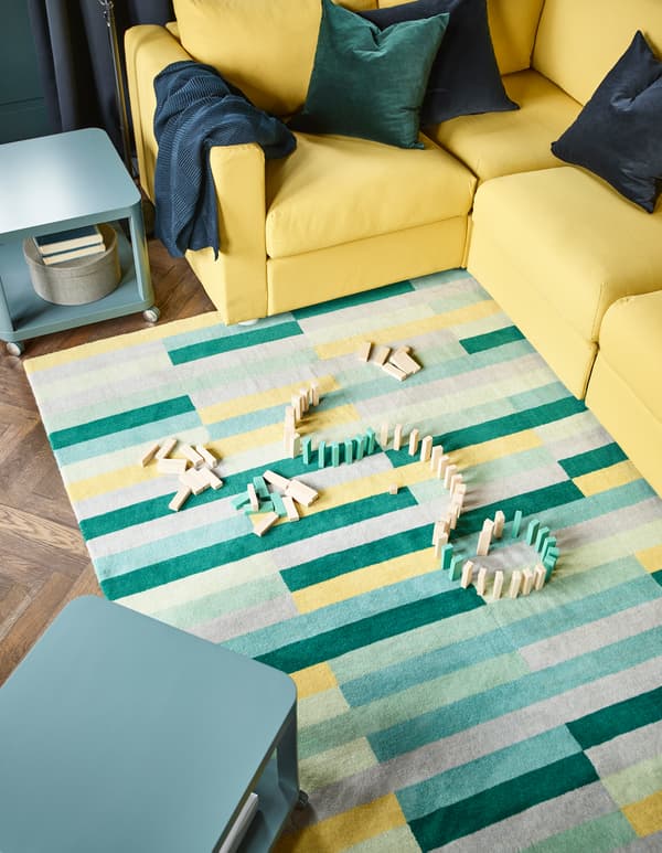 Want to let the kids play without worrying about spills? IKEA has lots of smart products, such as coffee tables with wheels that are easy to move. The handmade 100% wool mat in yellow, green and blue can be dry-cleaned if accidents do happen.