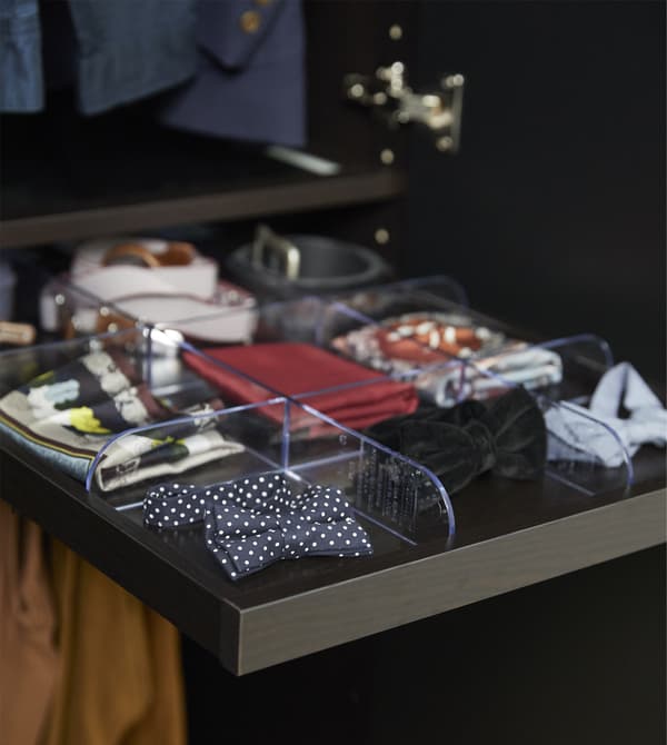 Wardrobe organizers can help keep your clothes sorted and make your mornings smoother. IKEA has a wide variety like KOMPLEMENT pull-out tray in black-brown. It’s shallow, so you can easily see smaller pieces like bow ties and belts.