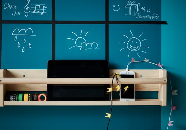 We hung a rack under our weekly organiser for smartphones and tablets to charge.