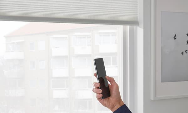 White cellular blind controlled by an app on a cell phone.
