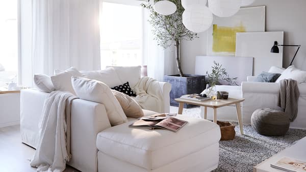 White GRÖNLID sofa and chaise and light wooden LISABO coffee table in a white-themed living room.