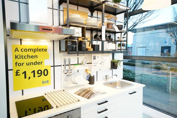 White kitchen with black shelfs on the wall