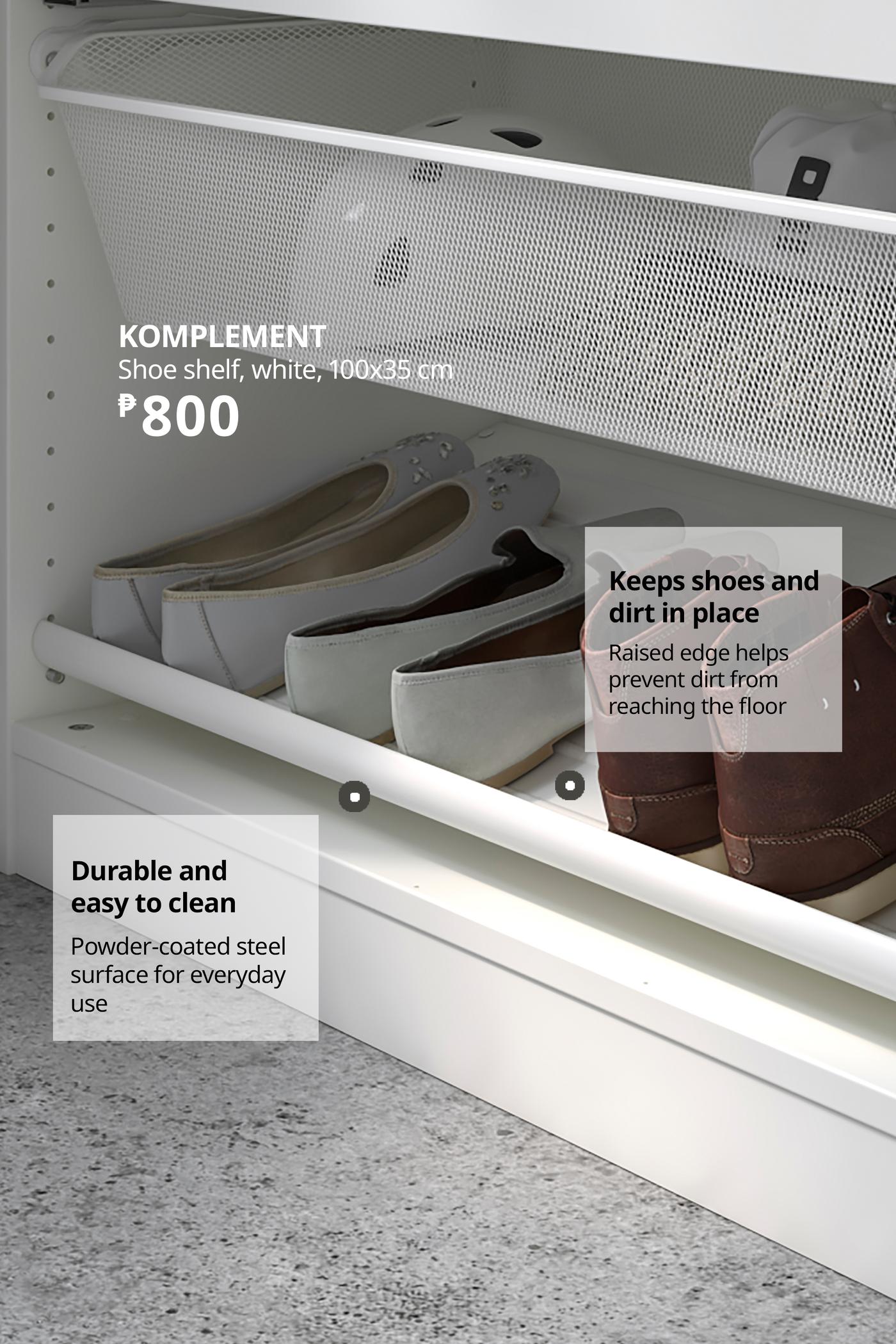 White KOMPLEMENT pull-out shoe shelf holding several pairs of shoes in a closet; raised edges keep dirt contained, with durable steel construction.