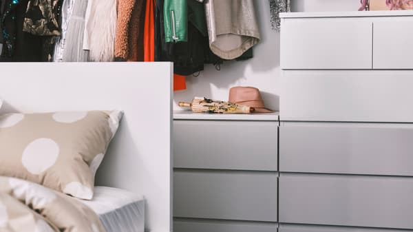 White MALM chest of drawers in different sizes behind the white MALM bed.