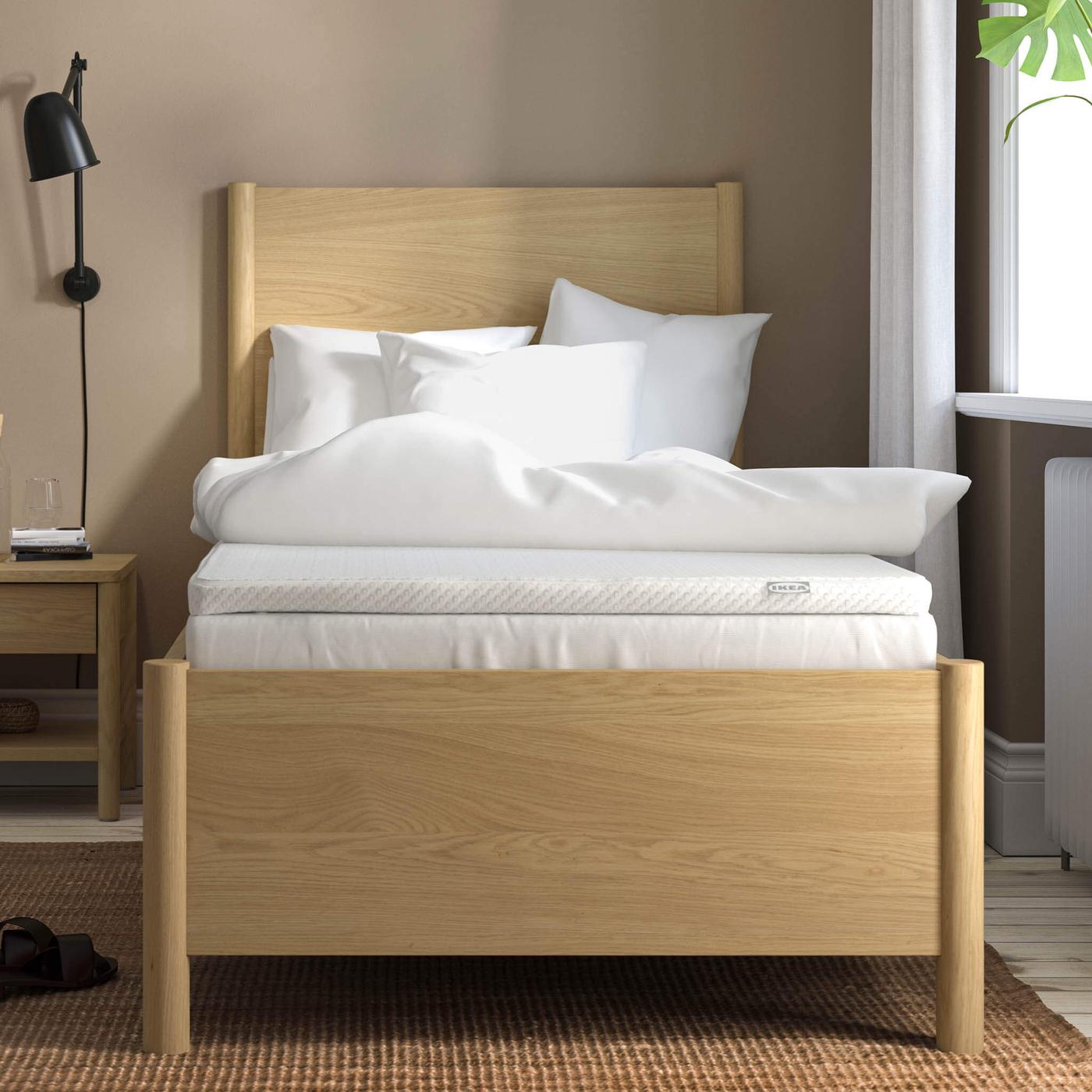 White mattress topper on bed.